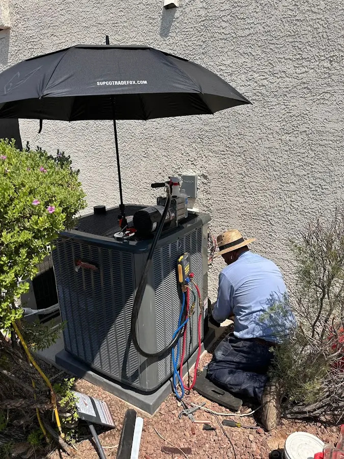 HVAC technician performing outdoor AC maintenance in Eustis